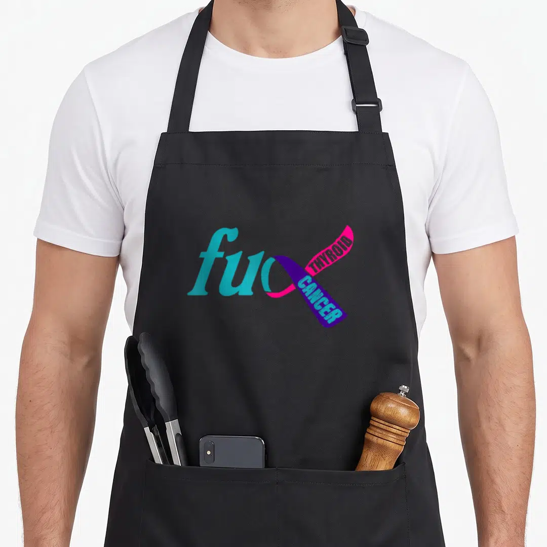 Awareness ribbon thyroid apron - cyan fu text merging into pink purple ribbon with THYROID CANCER lettering — shown on a black cotton canvas apron against a white background