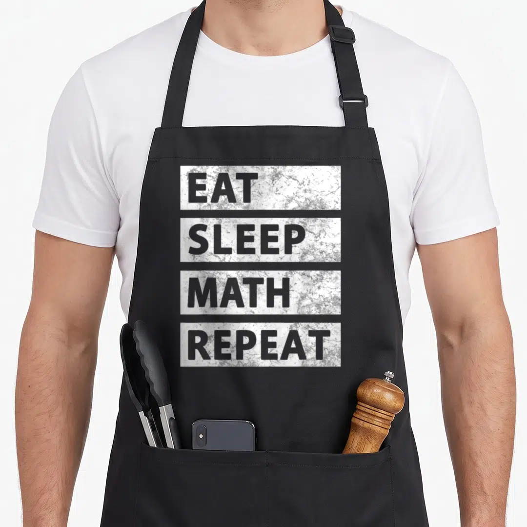 Mathematician eat teacher apron - Stacked white marble blocks with grey text EAT SLEEP MATH REPEAT on grey background — shown on a black cotton canvas apron against a white background