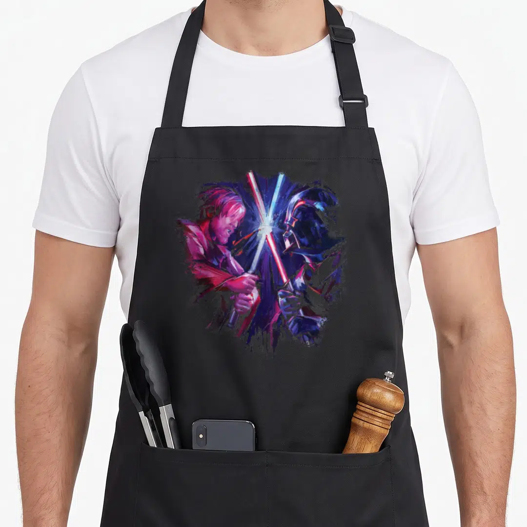 Duel the painted apron - Watercolor Luke Skywalker and Darth Vader in profile with crossed red blue purple and pink — shown on a black cotton canvas apron against a white background
