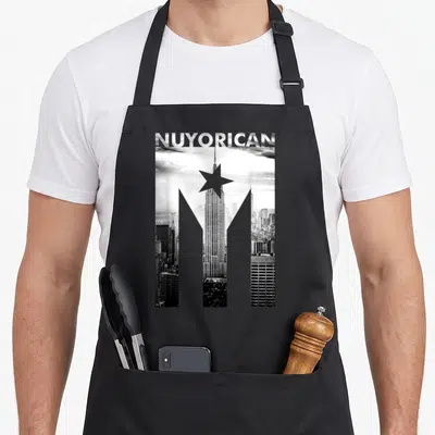 Nuyorican poet apron - Grayscale NYC skyline shaped like a Y with a star and NUYORICAN text — shown on a black cotton canvas apron against a white background