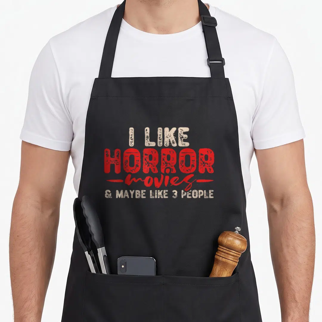 Crew horror movie apron - Red and beige text I LIKE HORROR movies & MAYBE LIKE 3 PEOPLE — shown on a black cotton canvas apron against a white background