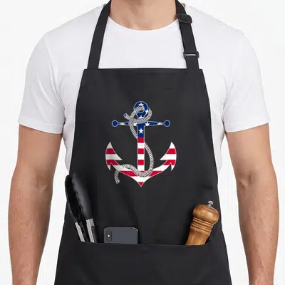 Anchor 4th of july apron - Minimalist anchor with red white blue flag pattern and wrapped rope — shown on a black cotton canvas apron against a white background