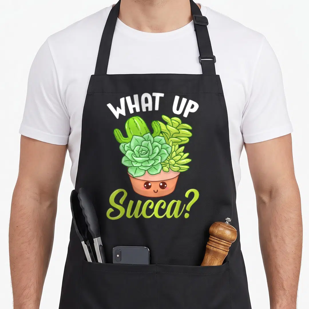 Punny cactus apron - Arched text surrounding a smiling terracotta pot filled with green succulents — shown on a black cotton canvas apron against a white background