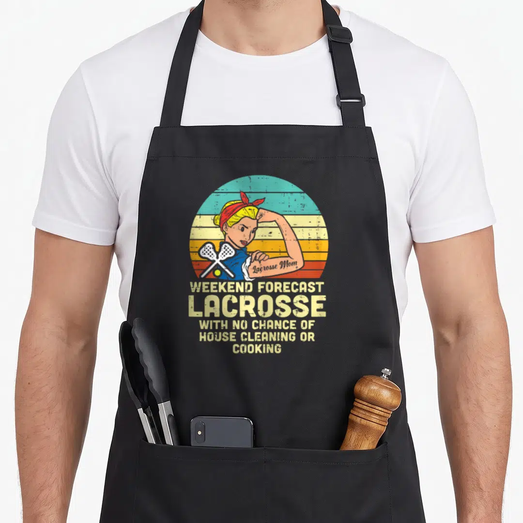 Strong mama apron - Retro woman flexing with crossed lacrosse sticks and forecast text on striped background — shown on a black cotton canvas apron against a white background
