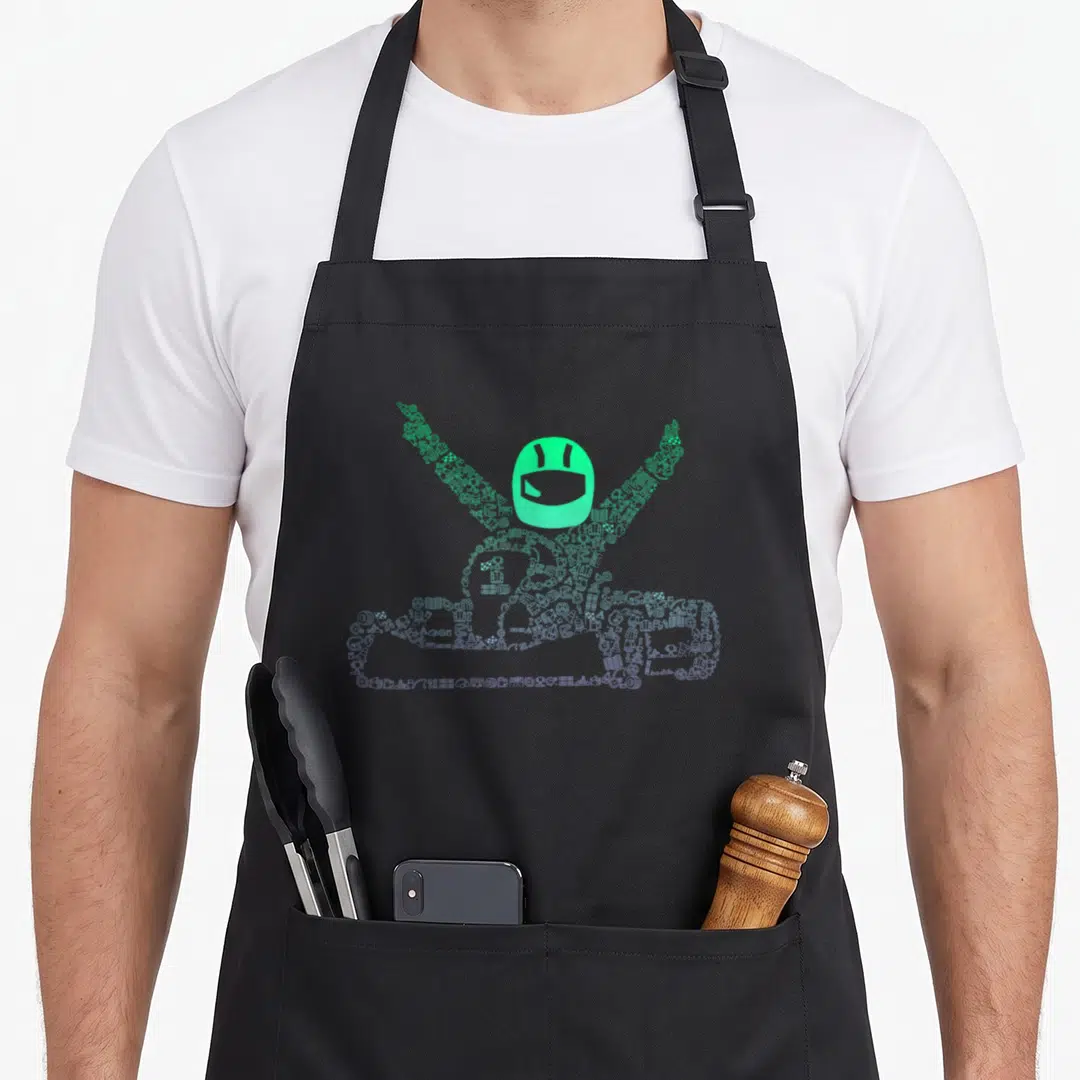 Kart track apron - Mint green racer silhouette formed by scattered icons and solid helmet — shown on a black cotton canvas apron against a white background