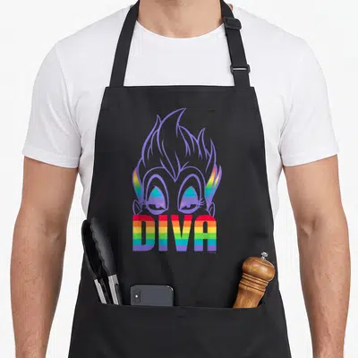 Villain pride apron - Purple-outlined cartoon face with rainbow eyes and DIVA text in striped letters — shown on a black cotton canvas apron against a white background