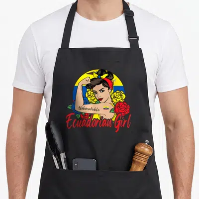 Mujer ecuadorian girl apron - Cartoon woman flexing arm with Unbreakable tattoo and Ecuadorian Girl text surrounded — shown on a black cotton canvas apron against a white background