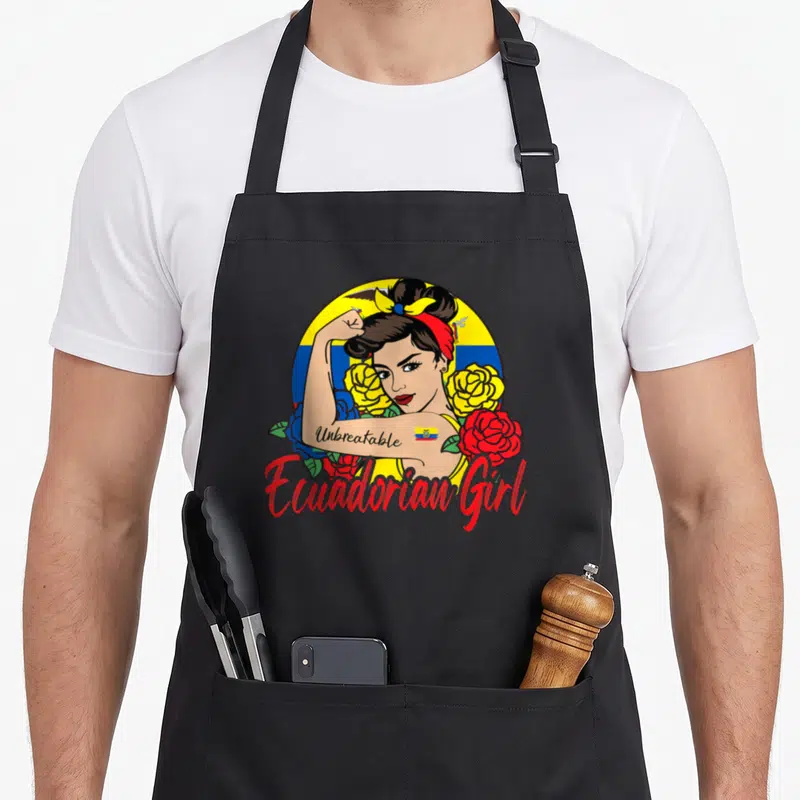 Mujer ecuadorian girl apron - Cartoon woman flexing arm with Unbreakable tattoo and Ecuadorian Girl text surrounded — shown on a black cotton canvas apron against a white background