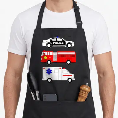 Police truck apron - Three stacked emergency vehicles: police car with 911 POLICE, red fire truck with No 1, white — shown on a black cotton canvas apron against a white background
