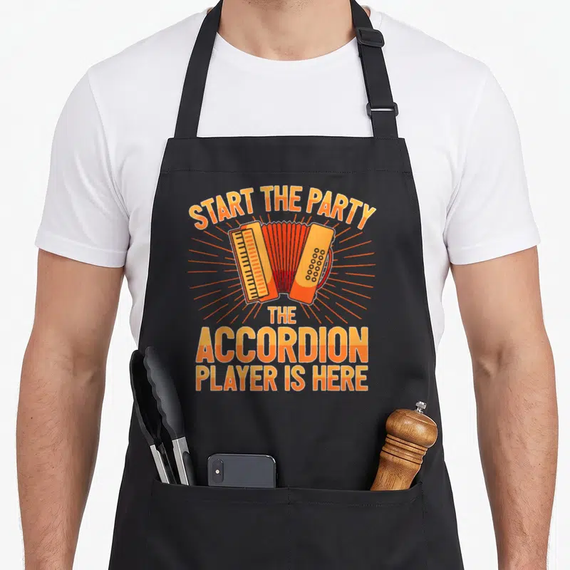 Accordionist accordion apron - Retro orange sunburst graphic with accordion and text Start The Party The Accordion — shown on a black cotton canvas apron against a white background
