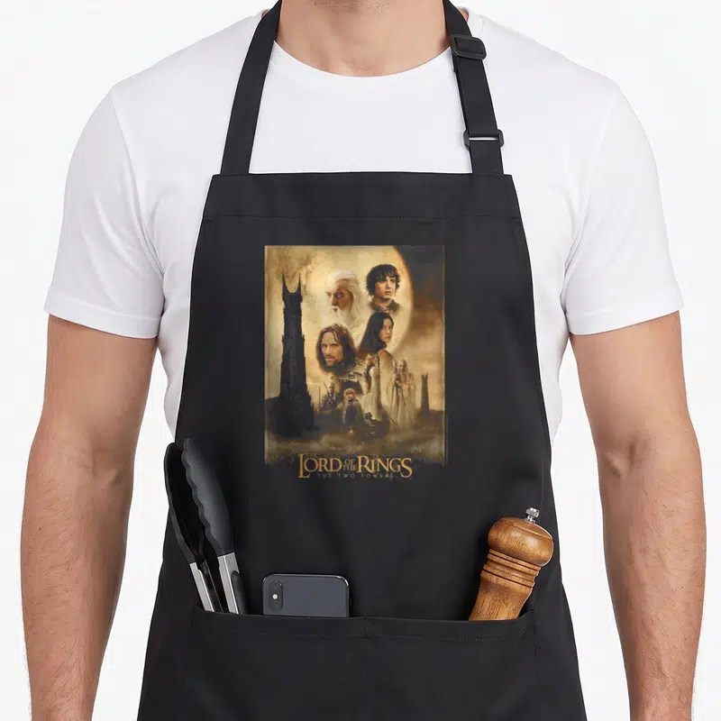 Poster ring apron - Montage of Gandalf and other characters with Two Towers text in brown and blue — shown on a black cotton canvas apron against a white background