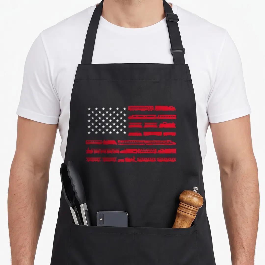 Conductor railroad train apron - US flag formed by red train silhouettes and white stars on black fabric — shown on a black cotton canvas apron against a white background