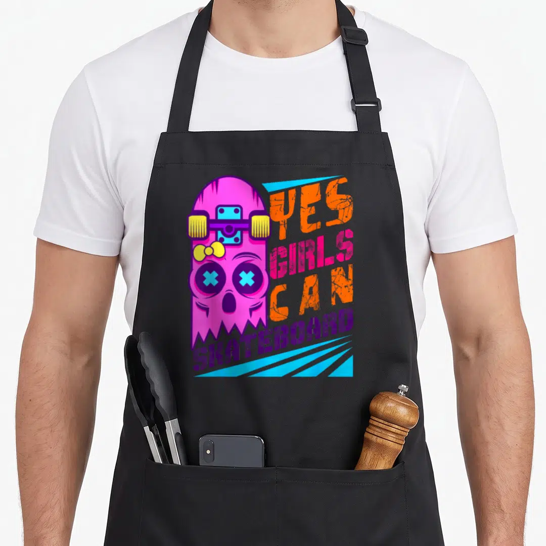 Skateboard skateboarder apron - Pink ghost with yellow bow holding skateboard next to Yes Girls Can Skateboard text — shown on a black cotton canvas apron against a white background