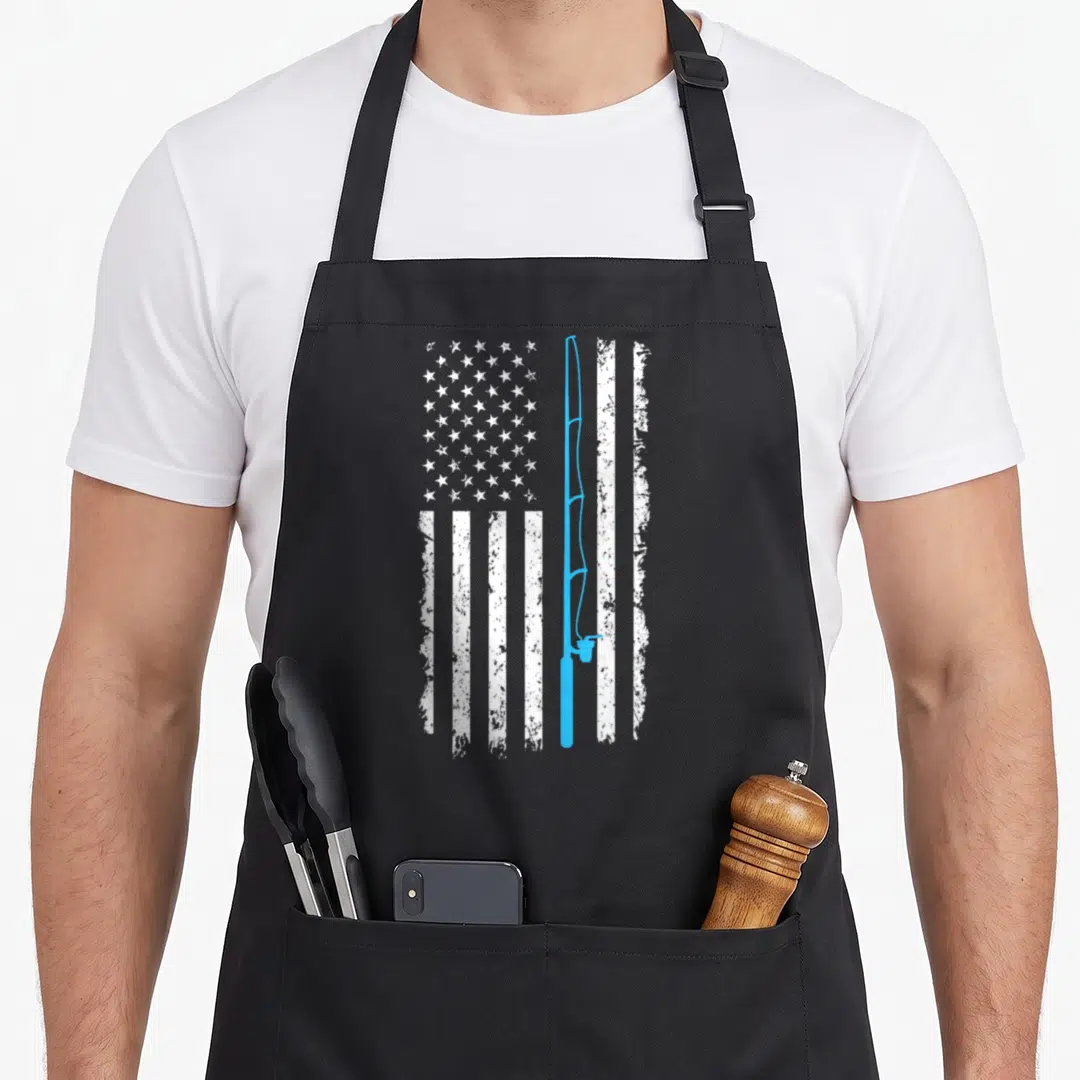 Fishing rod american flag apron - Vertical blue fishing rod replacing a stripe in a distressed white US flag pattern — shown on a black cotton canvas apron against a white background