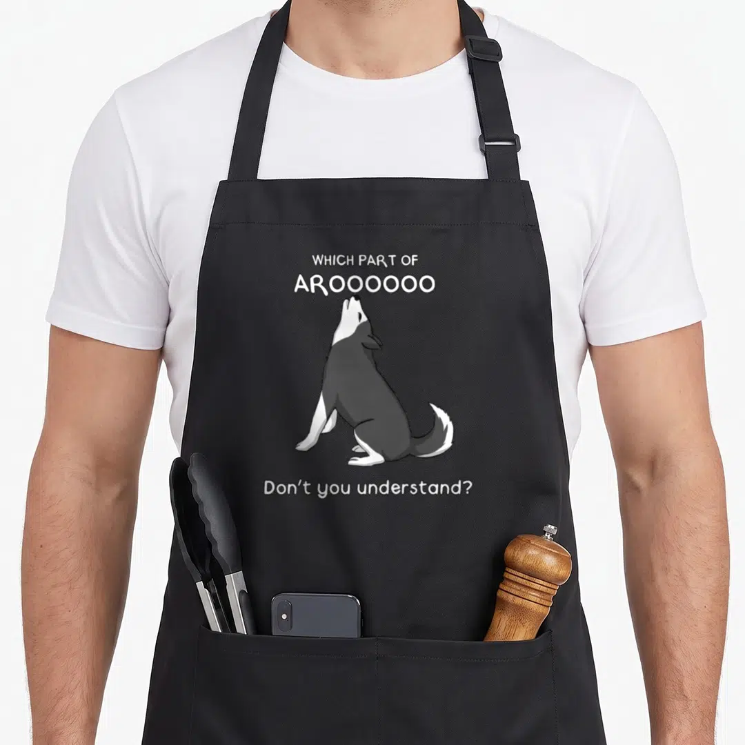 Part dog apron - Cartoon grey and white husky howling with text Which Part of Aroooo Don't You Understand — shown on a black cotton canvas apron against a white background