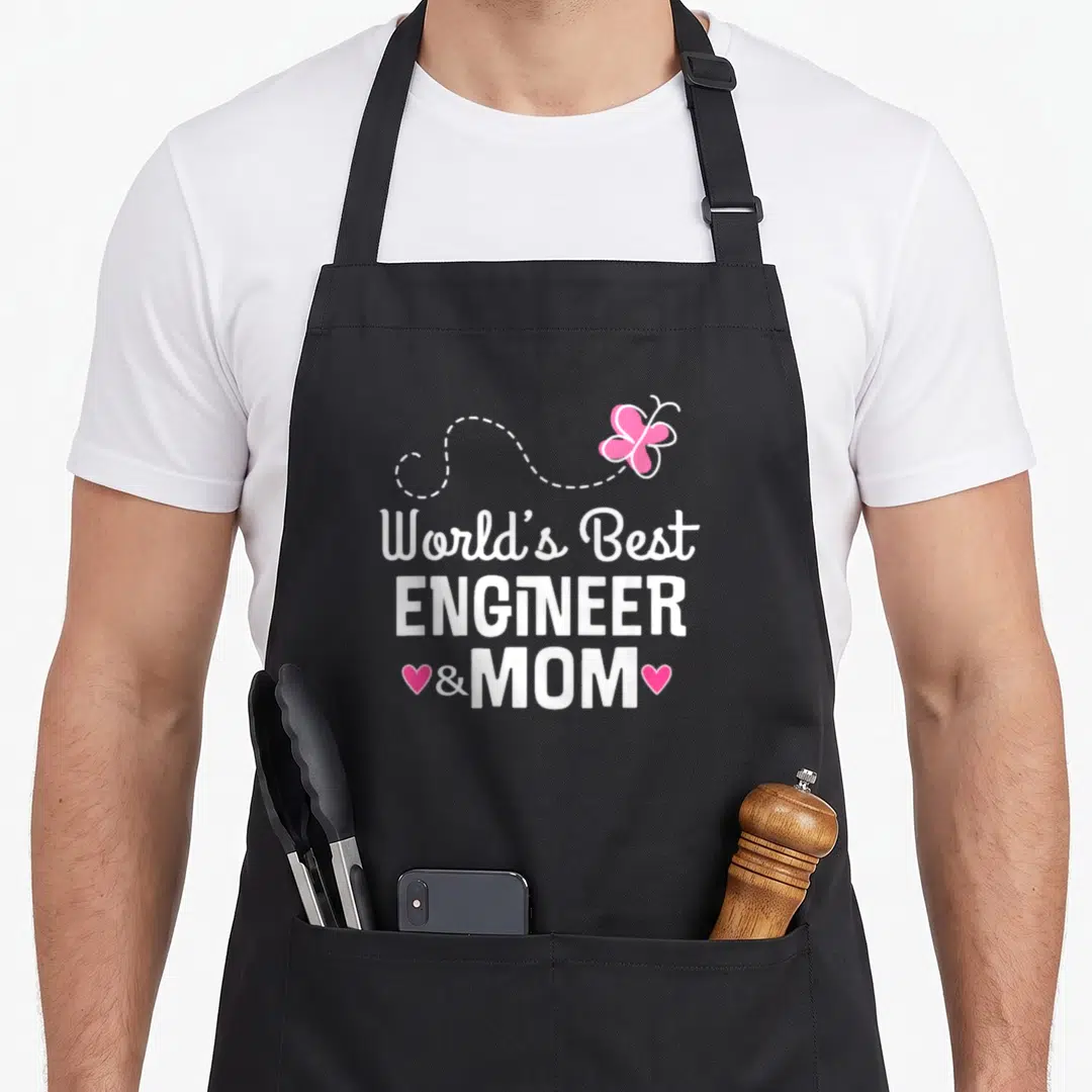 Engineering mother's day aprons - White text World's Best Engineer Mom with pink butterfly and hearts — shown on a black cotton canvas apron against a white background