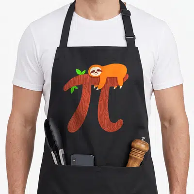 Sloth teacher apron - Orange cartoon sloth lying on reddish-brown pi symbol branch with three green leaves — shown on a black cotton canvas apron against a white background