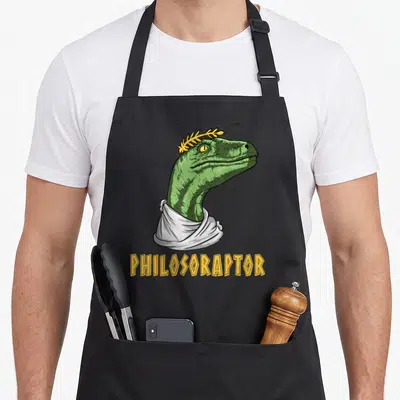 Philosophy major apron - Green raptor head wearing white toga and yellow laurel wreath above yellow text PHILOSORAPTOR — shown on a black cotton canvas apron against a white background
