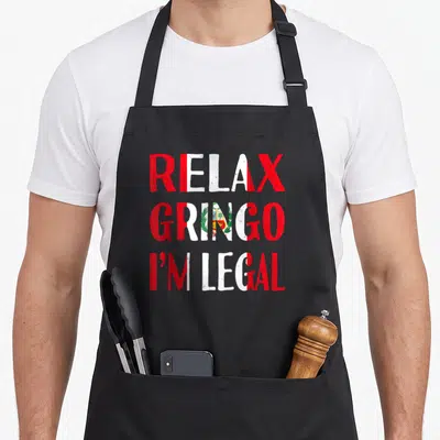 Relax peruvian apron - Stacked red and white text reading Relax Gringo I'm Legal with Peruvian flag emblem inside — shown on a black cotton canvas apron against a white background