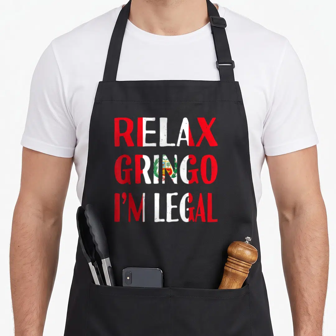 Relax peruvian apron - Stacked red and white text reading Relax Gringo I'm Legal with Peruvian flag emblem inside — shown on a black cotton canvas apron against a white background