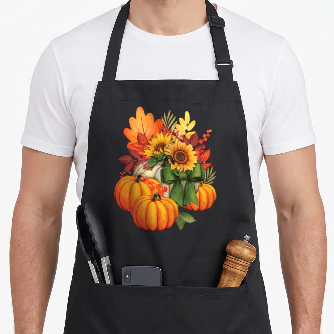 Sunflower fall aprons - Watercolor pumpkins sunflowers and autumn leaves with green ribbon bow — shown on a black cotton canvas apron against a white background