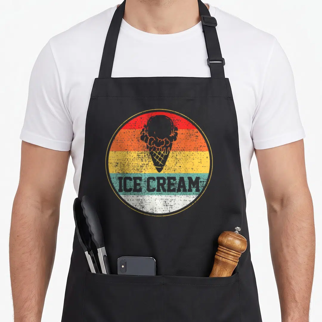 Treat ice cream apron - Retro ice cream cone on red orange yellow teal white stripes with grey text — shown on a black cotton canvas apron against a white background