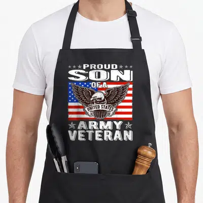 Family patriotic apron - Distressed eagle on red white and blue flag with Proud Son Of A United States Army Veteran text — shown on a black cotton canvas apron against a white background