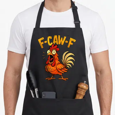 Fcawf rooster apron - Arched F-CAW-F text over a screaming orange cartoon chicken with red comb — shown on a black cotton canvas apron against a white background