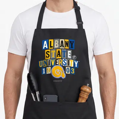 State albany apron - ALBANY STATE UNIVERSITY 1903 text in colored blocks with ram head logo overlapping date — shown on a black cotton canvas apron against a white background