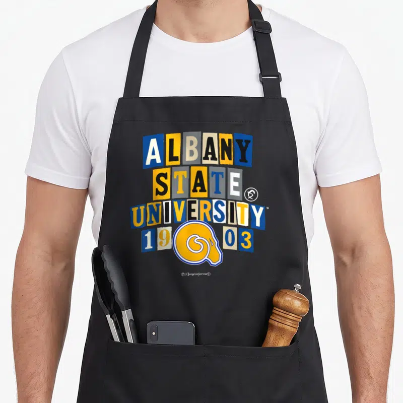 State albany apron - ALBANY STATE UNIVERSITY 1903 text in colored blocks with ram head logo overlapping date — shown on a black cotton canvas apron against a white background