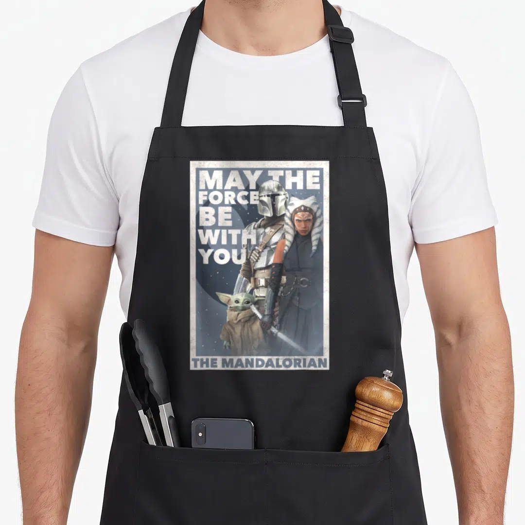 Force may look apron - Mandalorian Ahsoka and Grogu photo with May The Force Be With You text — shown on a black cotton canvas apron against a white background