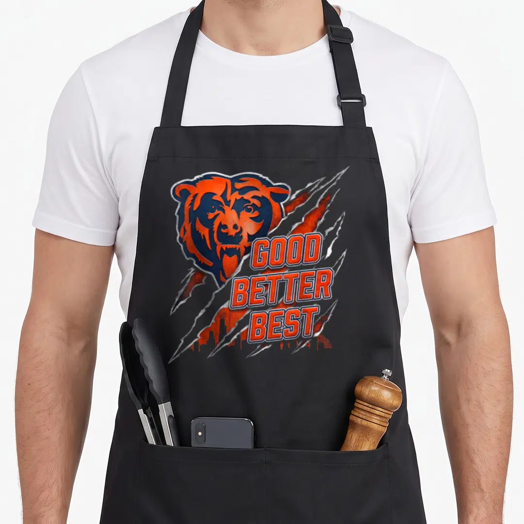 Motivational better apron - Stylized bear head with orange and silver claw marks and stacked text GOOD BETTER BEST — shown on a black cotton canvas apron against a white background