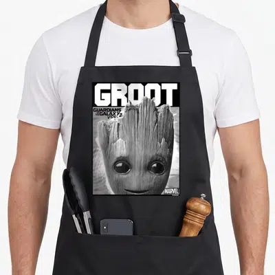 Close defender apron - Realistic Groot face with Guardians of the Galaxy Vol 2 text and black border — shown on a black cotton canvas apron against a white background