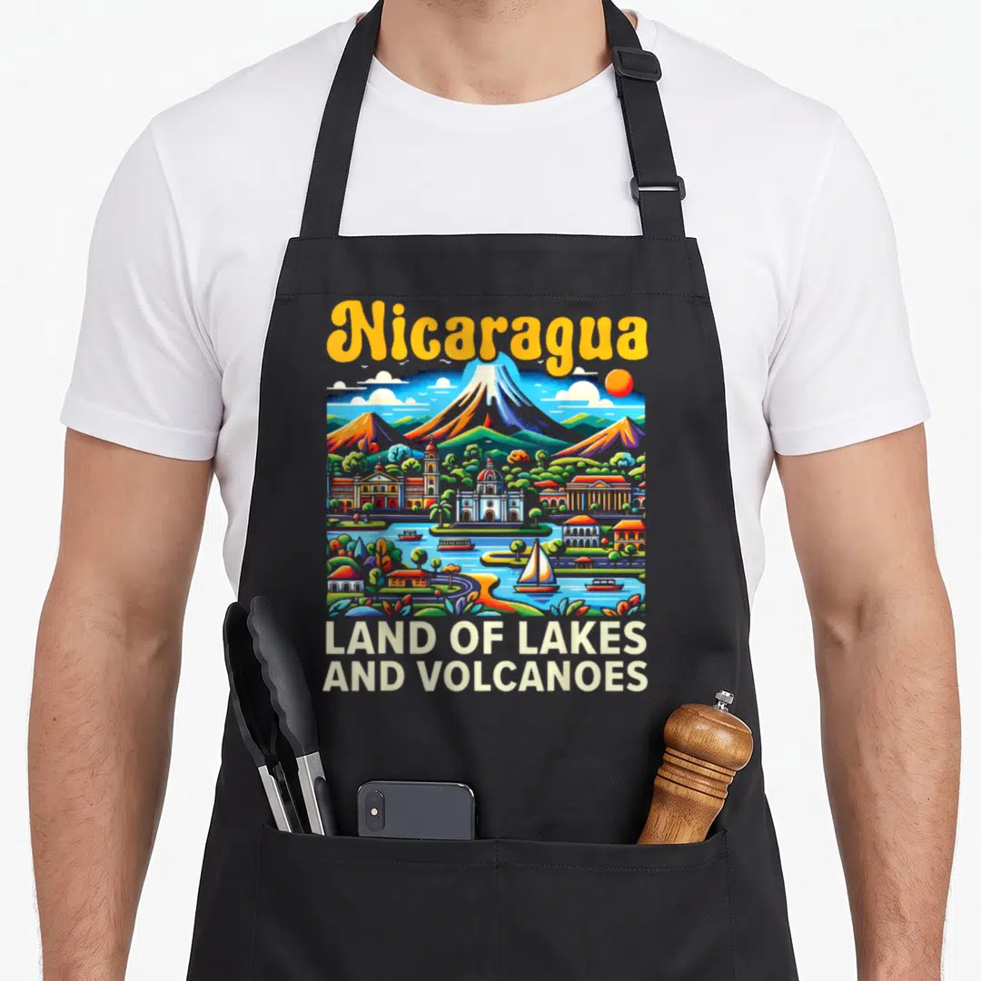 Nicaragua country apron - Colorful volcano landscape with Nicaragua text and Land of Lakes slogan — shown on a black cotton canvas apron against a white background