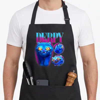 Derpy trend apron - Blue cat with DERPY text and two circular portrait insets in pink and yellow — shown on a black cotton canvas apron against a white background