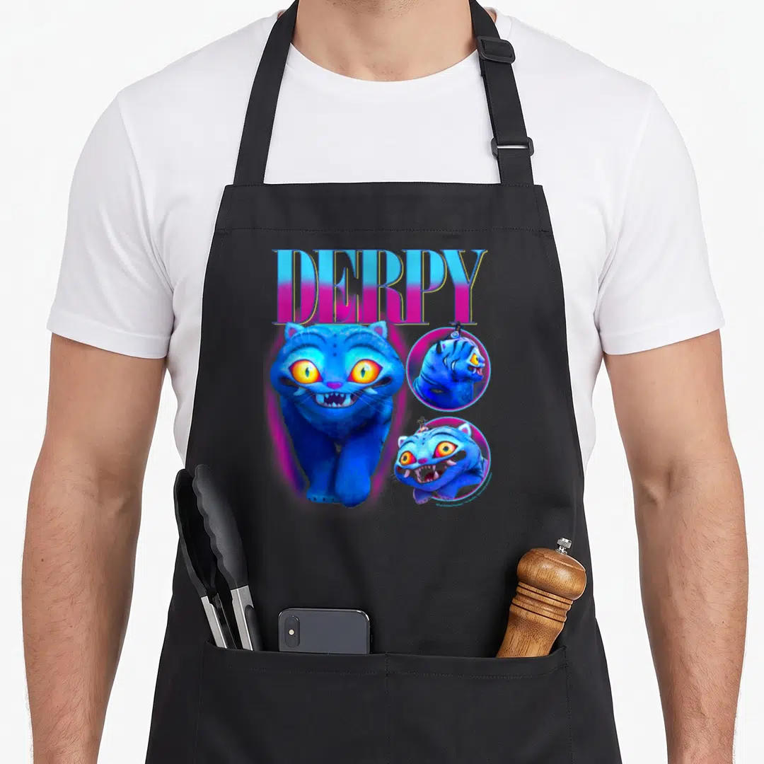 Derpy trend apron - Blue cat with DERPY text and two circular portrait insets in pink and yellow — shown on a black cotton canvas apron against a white background