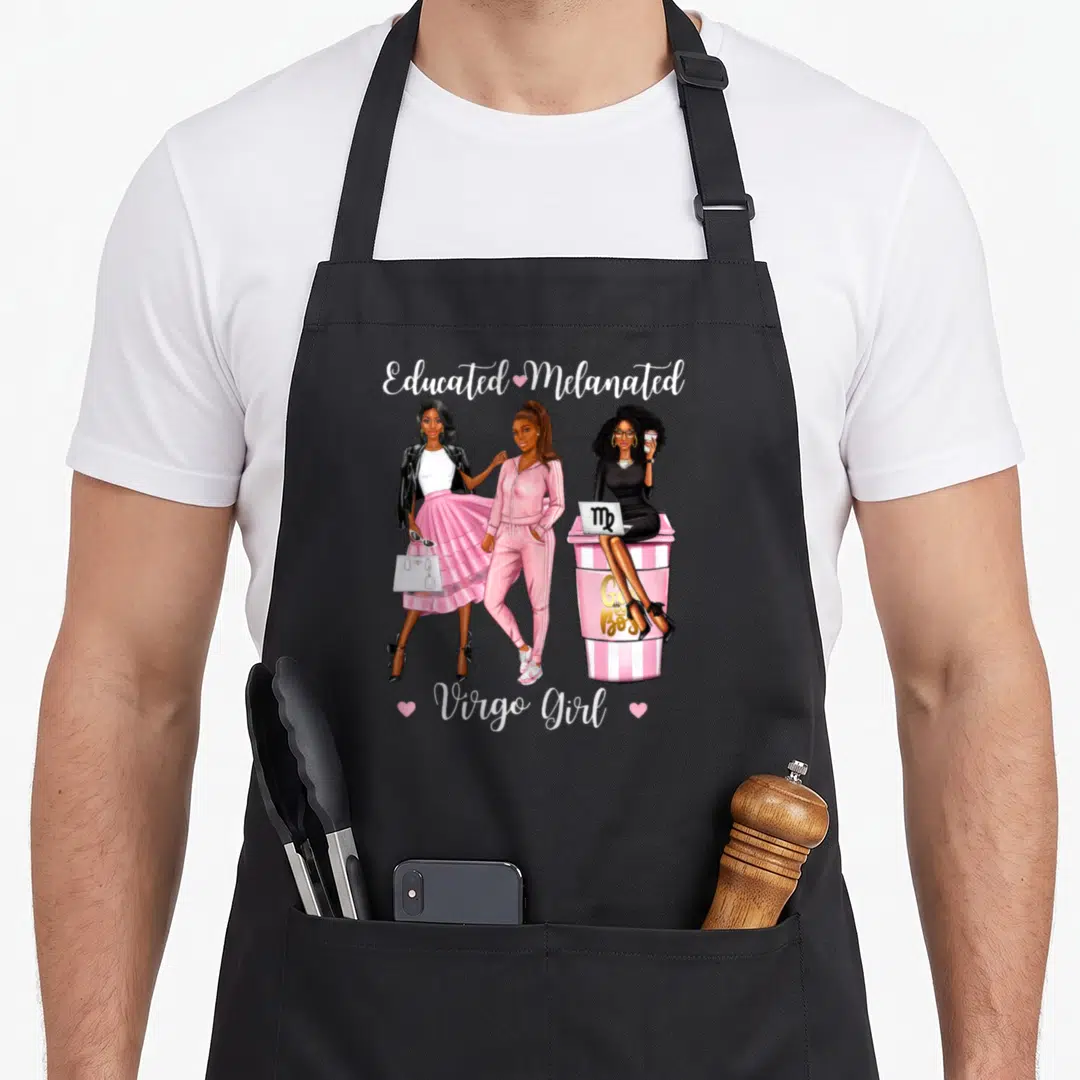 Educated birthday apron - Three women cartoon with Educated Melanated and Girl Boss text in pink and black — shown on a black cotton canvas apron against a white background