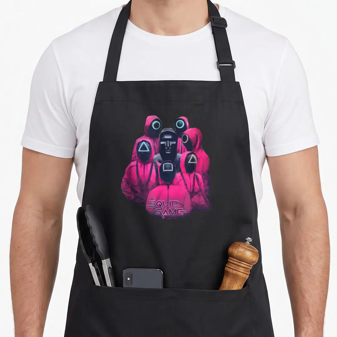 Guard ring apron - Pink masked guards with triangle square circle masks and SQUID GAME logo — shown on a black cotton canvas apron against a white background