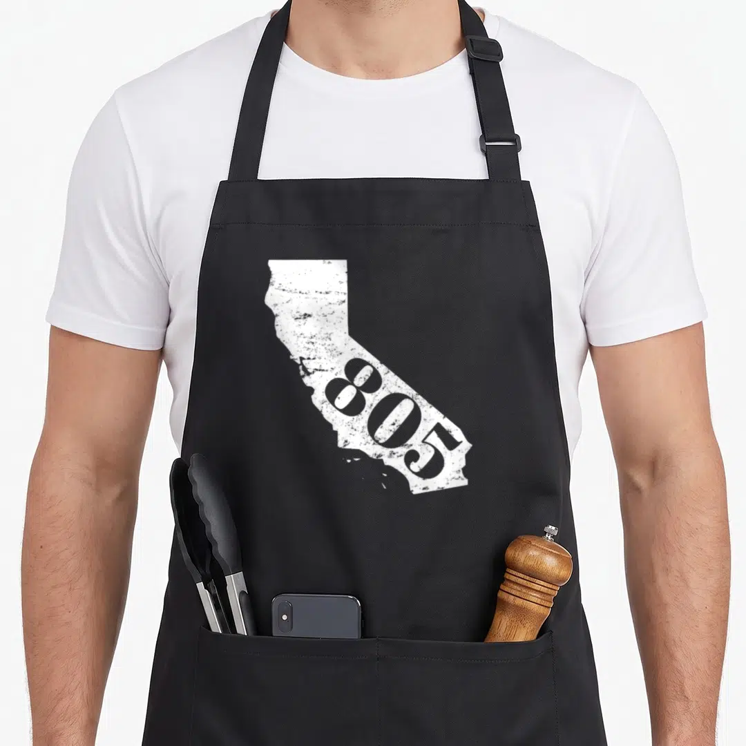Code santa apron - White distressed California map silhouette with 805 area code text overlay — shown on a black cotton canvas apron against a white background