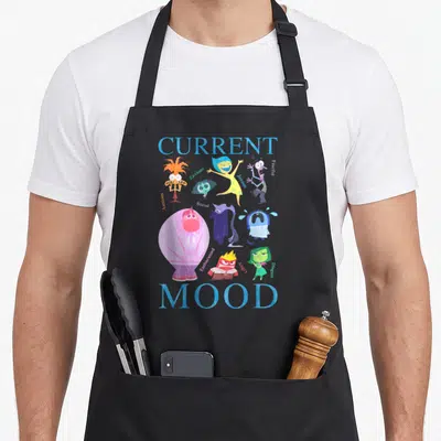 Current novelty apron - Cartoon emotion characters labeled Anxious Joyous Fearful Bored Sad Embarrassed Angry Disgust — shown on a black cotton canvas apron against a white background