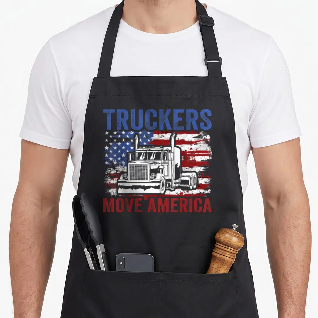 Moving truck apron - TRUCKERS MOVE AMERICA text with white truck on distressed red white blue flag — shown on a black cotton canvas apron against a white background