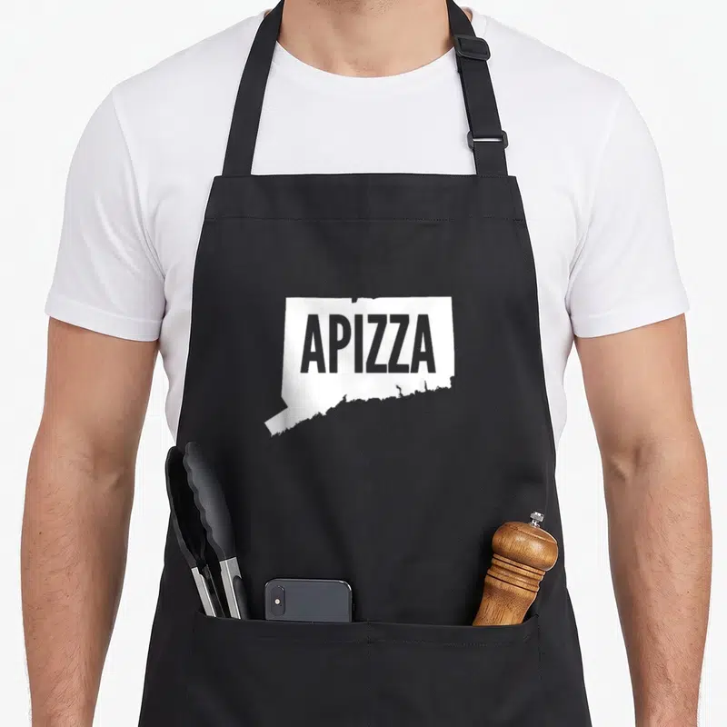 Haven connecticut apron - White Connecticut state outline with grey APizza text centered inside on grey background — shown on a black cotton canvas apron against a white background