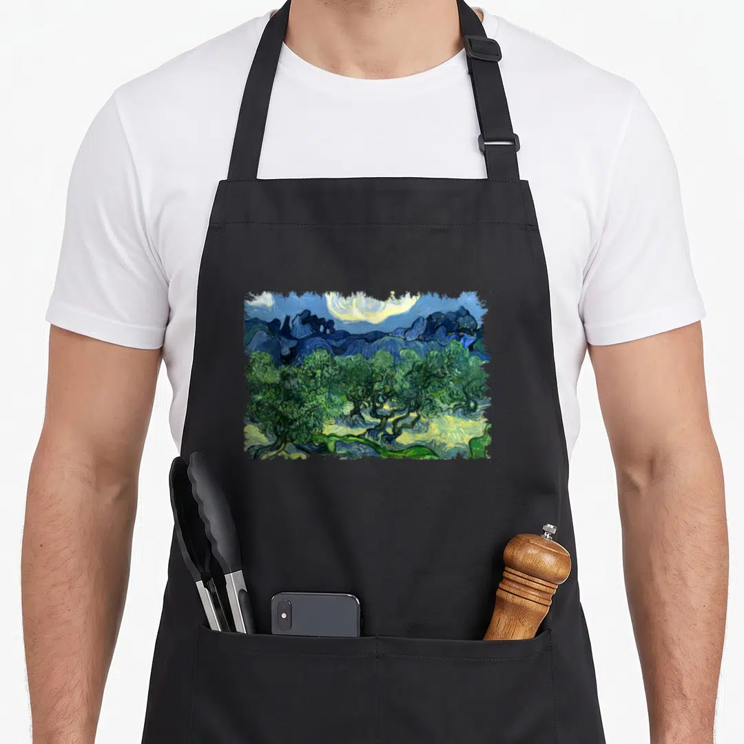 Gogh tree aprons - Rectangular landscape with olive trees, mountains, and swirling sky in blue, green, and yellow — shown on a black cotton canvas apron against a white background