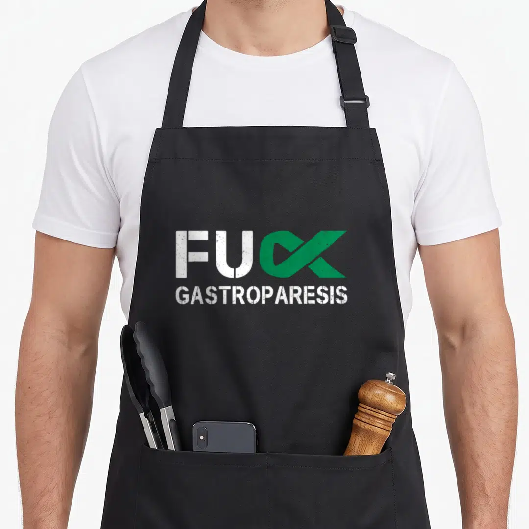 Gastroparesis awareness ribbon apron - FUC GASTROPARESIS text with green ribbon replacing the letter K — shown on a black cotton canvas apron against a white background