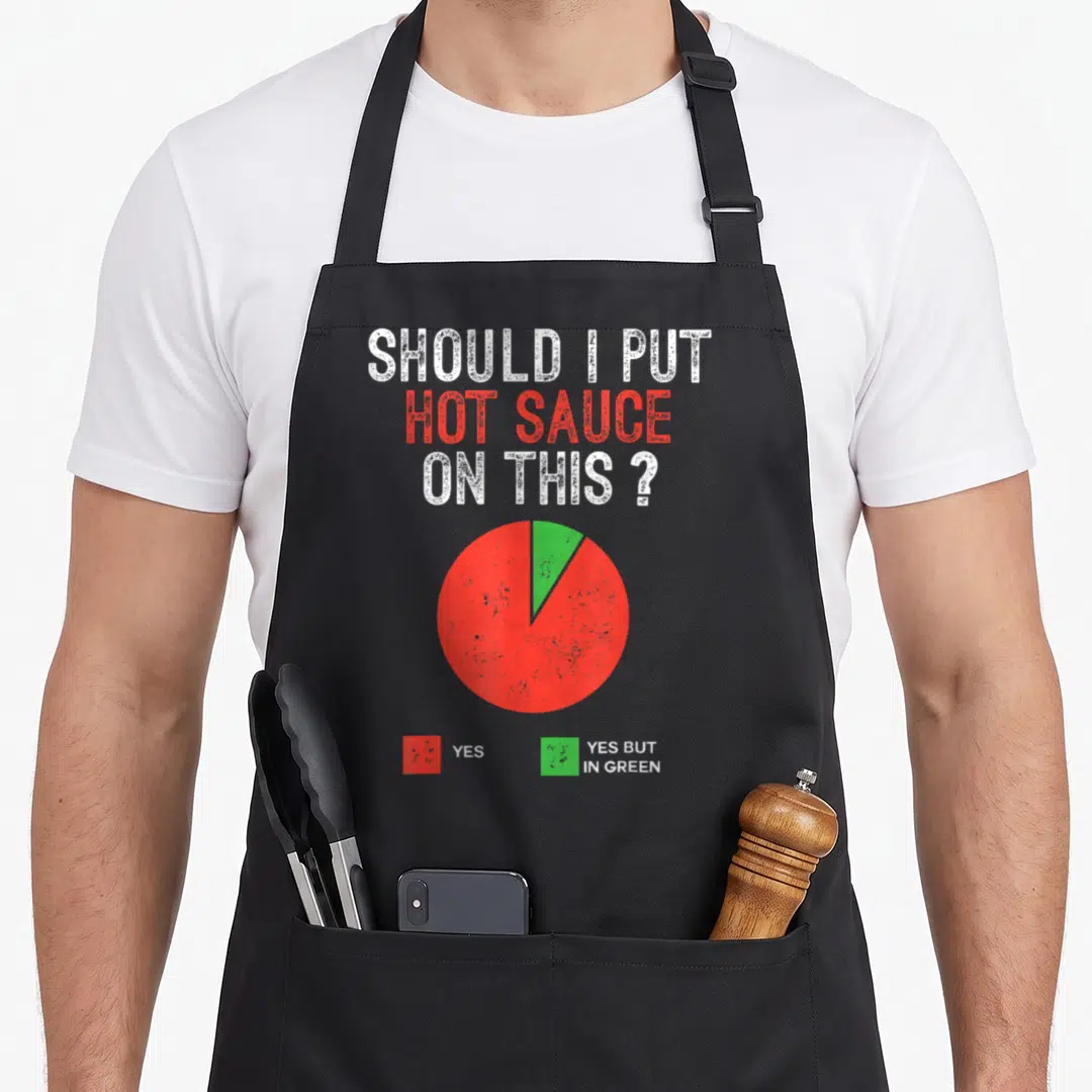 Should pie apron - Pie chart asking should i put hot sauce on this yes yes but in green — shown on a black cotton canvas apron against a white background