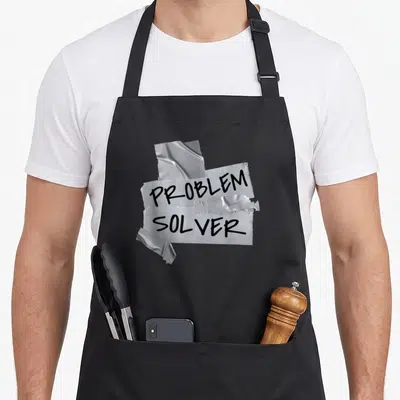 Solver warehouse problems apron - Silver duct tape strips with black PROBLEM SOLVER text in realistic style — shown on a black cotton canvas apron against a white background