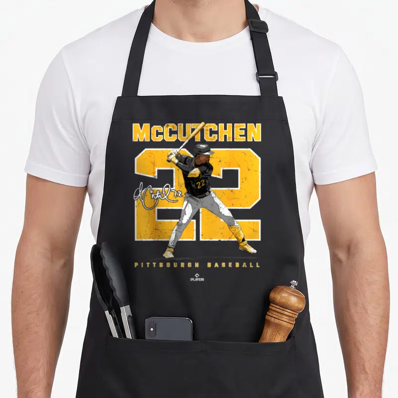 Ballpark modern apron - McCutchen 22 Pittsburgh Baseball player graphic with yellow number and signature — shown on a black cotton canvas apron against a white background