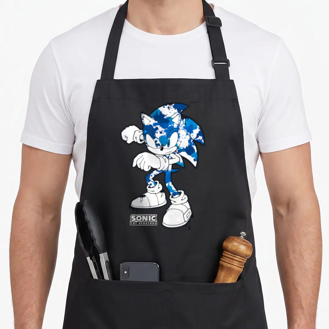 Dripping urban apron - Blue and white Sonic character with black dripping paint and logo text — shown on a black cotton canvas apron against a white background
