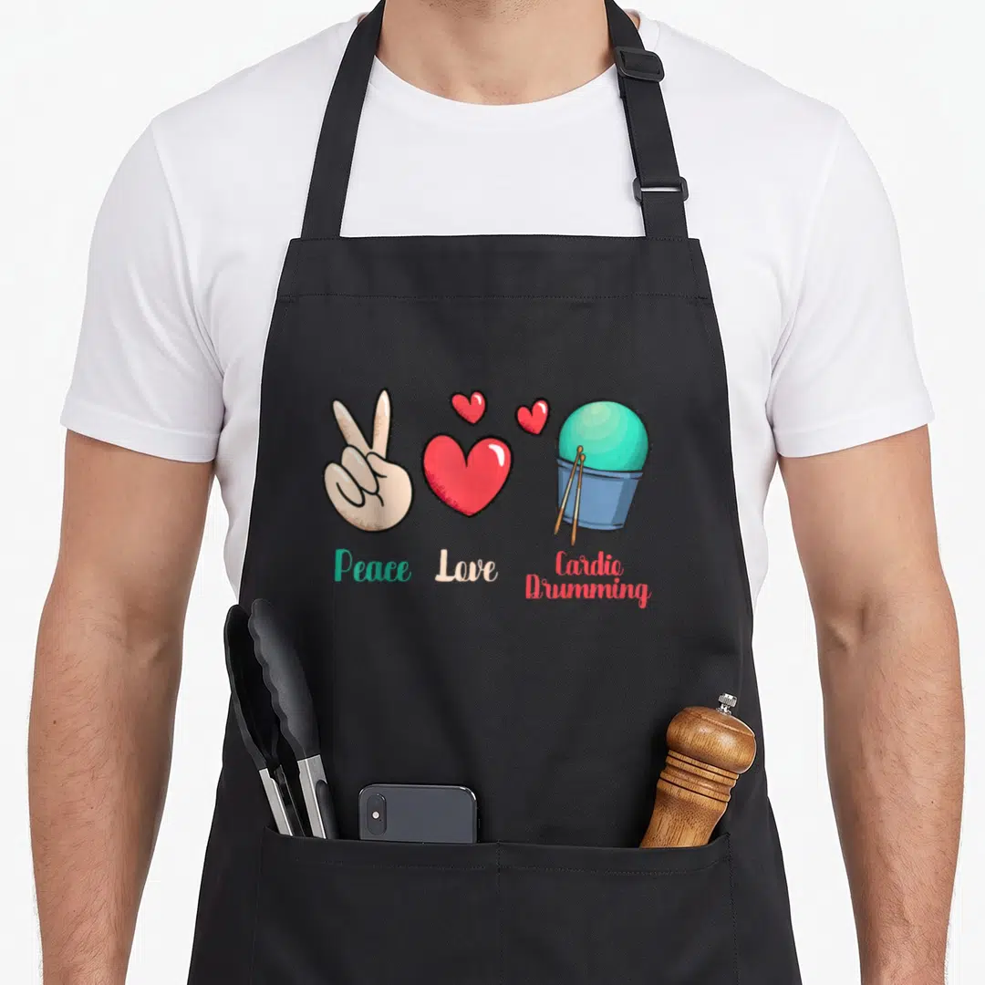 Fitness gym class apron - Cartoon hand, red hearts, blue bucket with sticks and text Peace Love Cardio Drumming — shown on a black cotton canvas apron against a white background