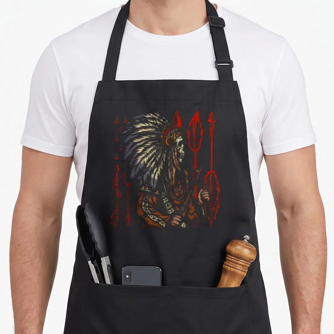 Headdress skull native american aprons - Distressed chief profile with teepees and red arrows in earth tones — shown on a black cotton canvas apron against a white background